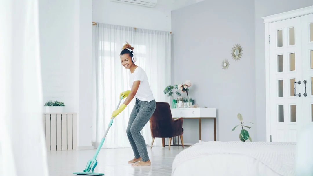 why-choose-us A woman carefully wraps a sofa in protective material while packing boxes in a bright room.